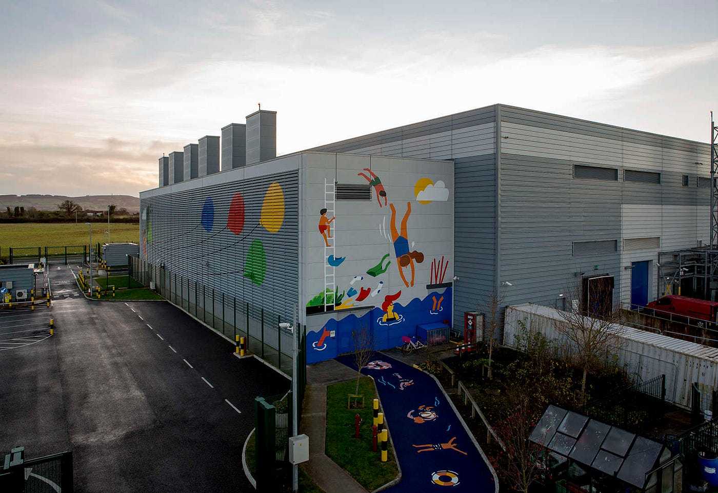 Fuchsia MacAree's mural on Google's Dublin, Ireland data center, painted across the building's louvered walls.