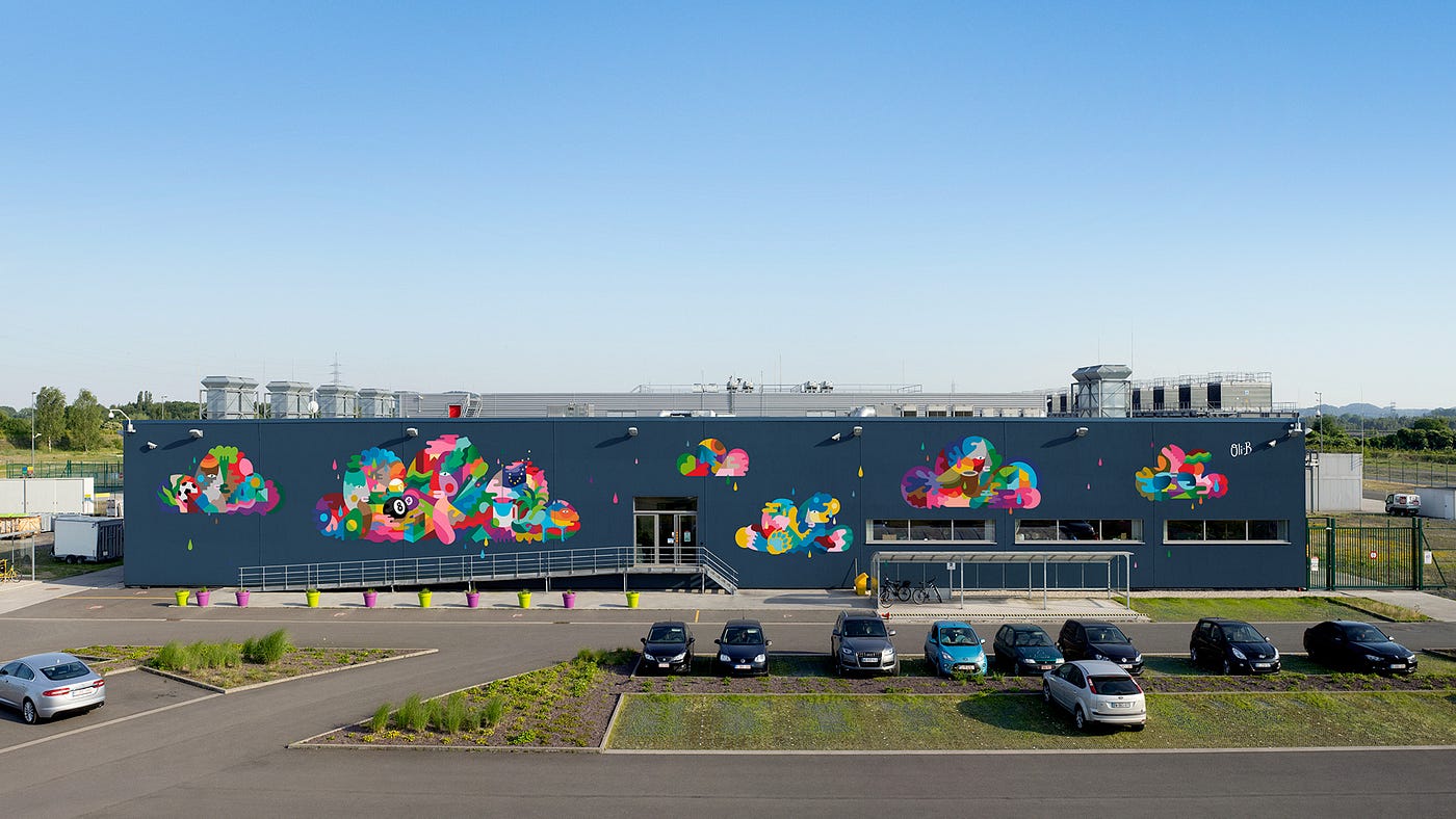 Oli-B's abstract mural across the facade of Google's St. Ghislain, Belgium data center.